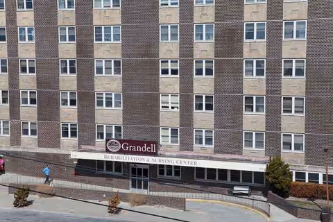 Brick facade of Grandell Rehabilitation and Nursing Center with front entrance.