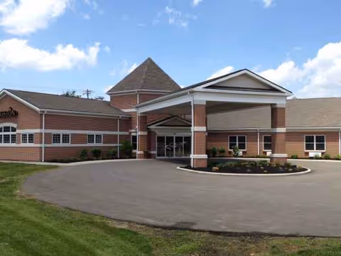 Exterior view of Kingston of Vermilion, a brick senior living facility with a covered entrance.
