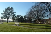 Lawn with benches and trees outside Susquehanna Valley Nursing and Rehab Center