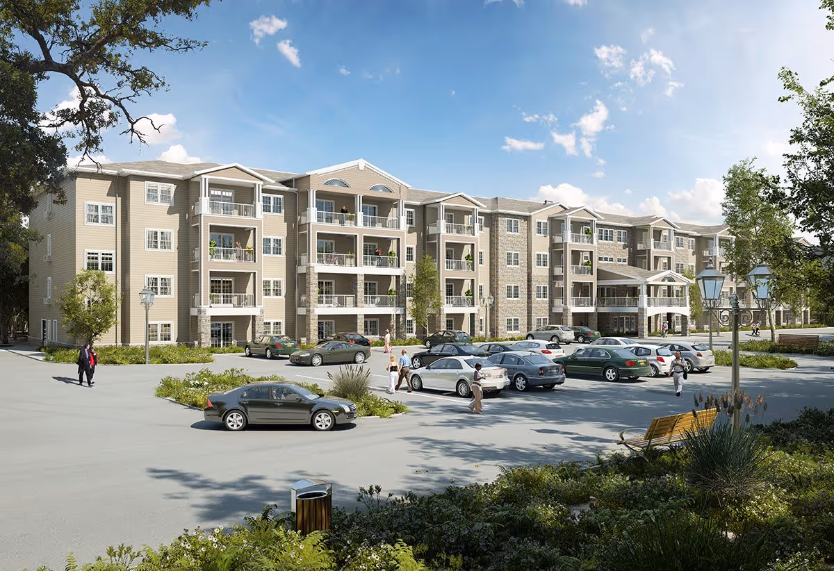 Exterior view of Glenmont Abbey Village, a multi-story senior living facility with balconies, surrounded by a parking lot with several cars and a few people walking. The scene includes trees, shrubs, and a clear blue sky with some clouds.