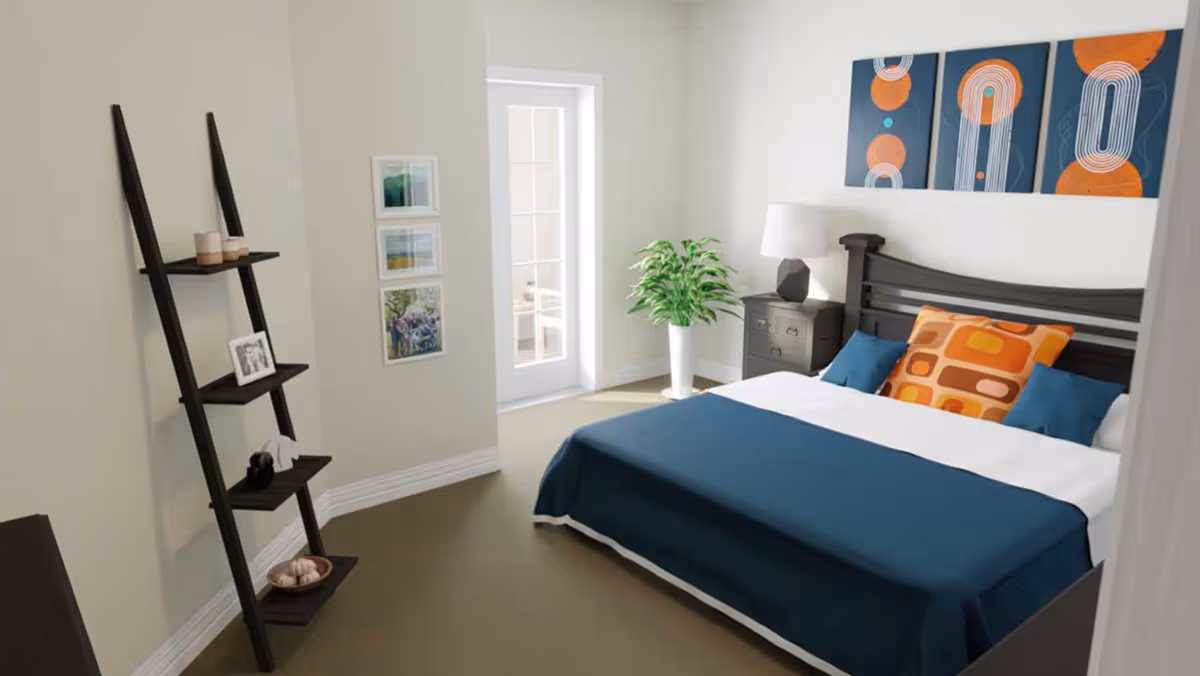 A bedroom with a bed covered in a blue blanket and decorated with orange and blue pillows. There is a black nightstand with a white lamp and a green plant in a white pot next to the bed. On the wall above the bed are three abstract art pieces with blue and orange designs. A black leaning shelf with decorative items and framed pictures is against the opposite wall. A door with glass panels leads to another room.