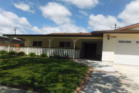 Front view of a single-story facility with a covered porch and green lawn.