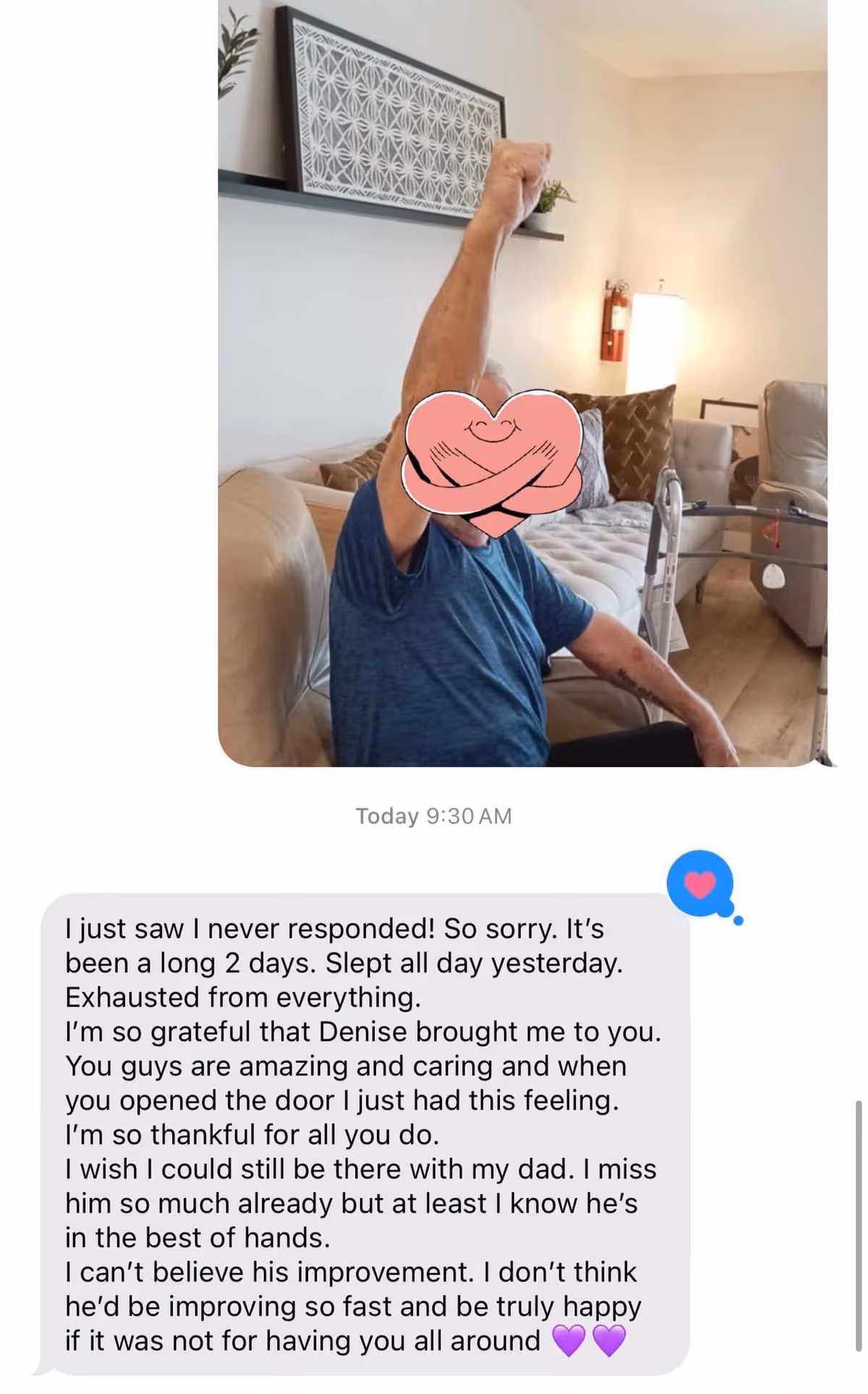 A seated person on a couch in a living-room area raising one arm, with a walker, lamp, cushions, wall decor, and a text-message screenshot visible below.