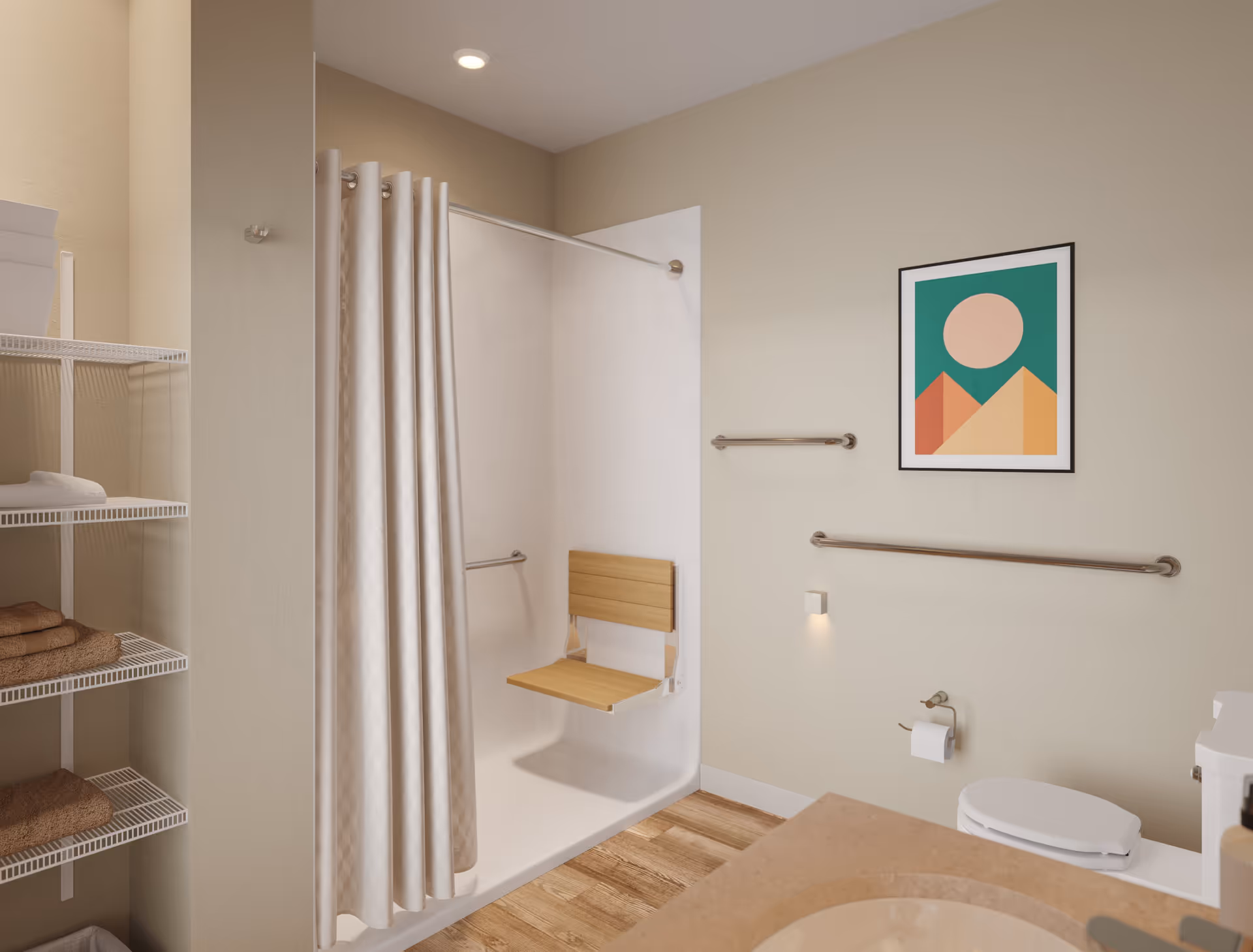 A bathroom with a walk-in shower featuring a foldable wooden seat and grab bars. The room has beige walls, a framed abstract artwork, a toilet with a grab bar, a countertop with a sink, and open shelving with folded towels.