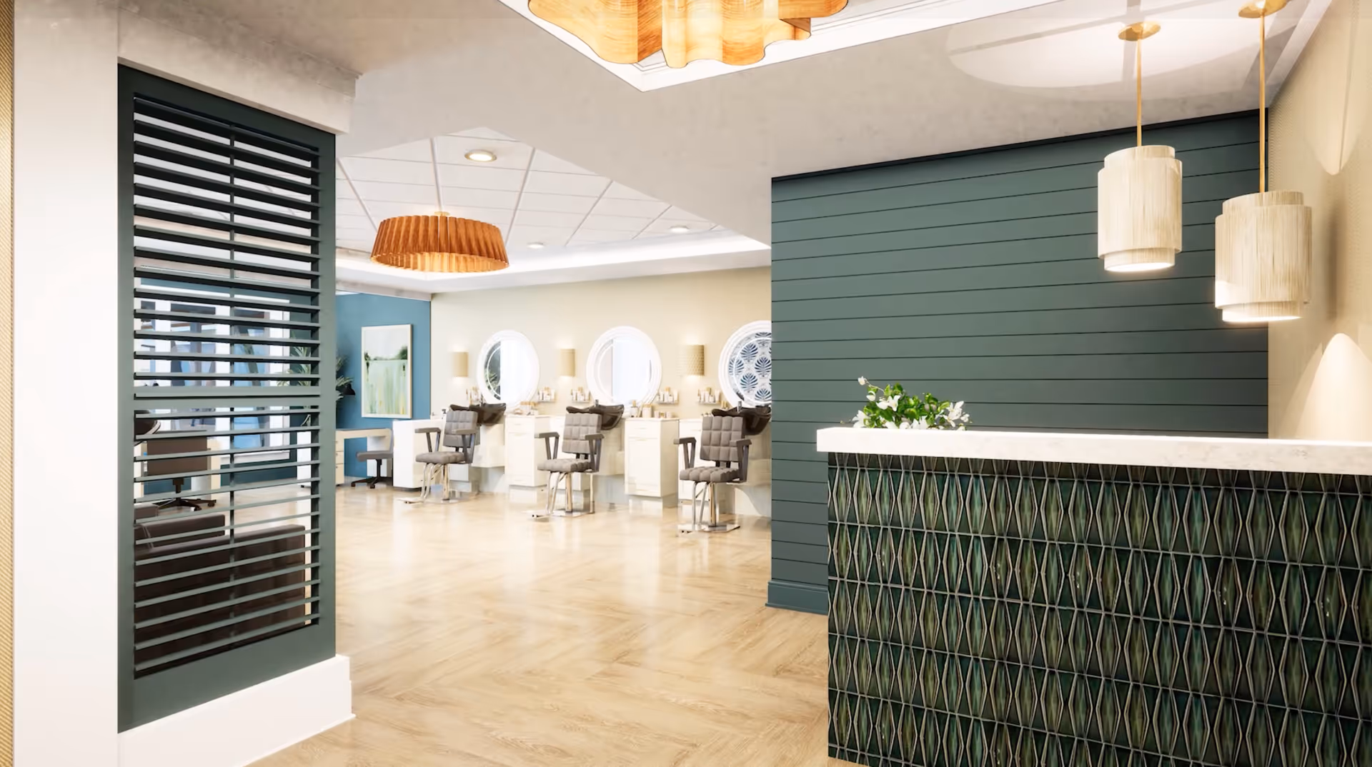 Interior view of a modern salon area with a reception desk on the right featuring a green patterned front and two hanging pendant lights. In the background, there are several styling stations with round mirrors and salon chairs. The floor is light wood, and the walls are painted in shades of green and beige.