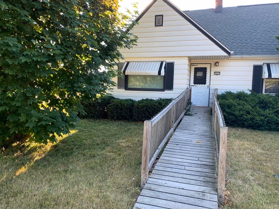 Front exterior view of a single-story adult family home with ramp access.