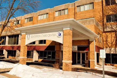 Brick Edgerton Care Center exterior with entrance canopy and snow in front.