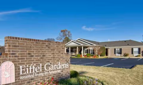 Exterior view of Eiffel Gardens assisted living facility with brick sign