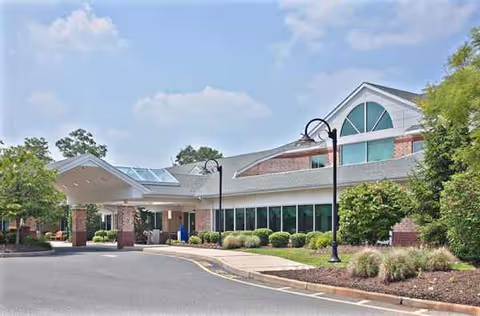 Exterior view of Jersey Shore Center with entrance, parking, and landscaped surroundings.