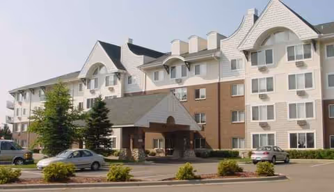 Exterior view of Westridge Retirement Community building with entrance and parked cars.