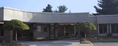 Front view of Medilodge of Kalamazoo facility with a curved entrance canopy.