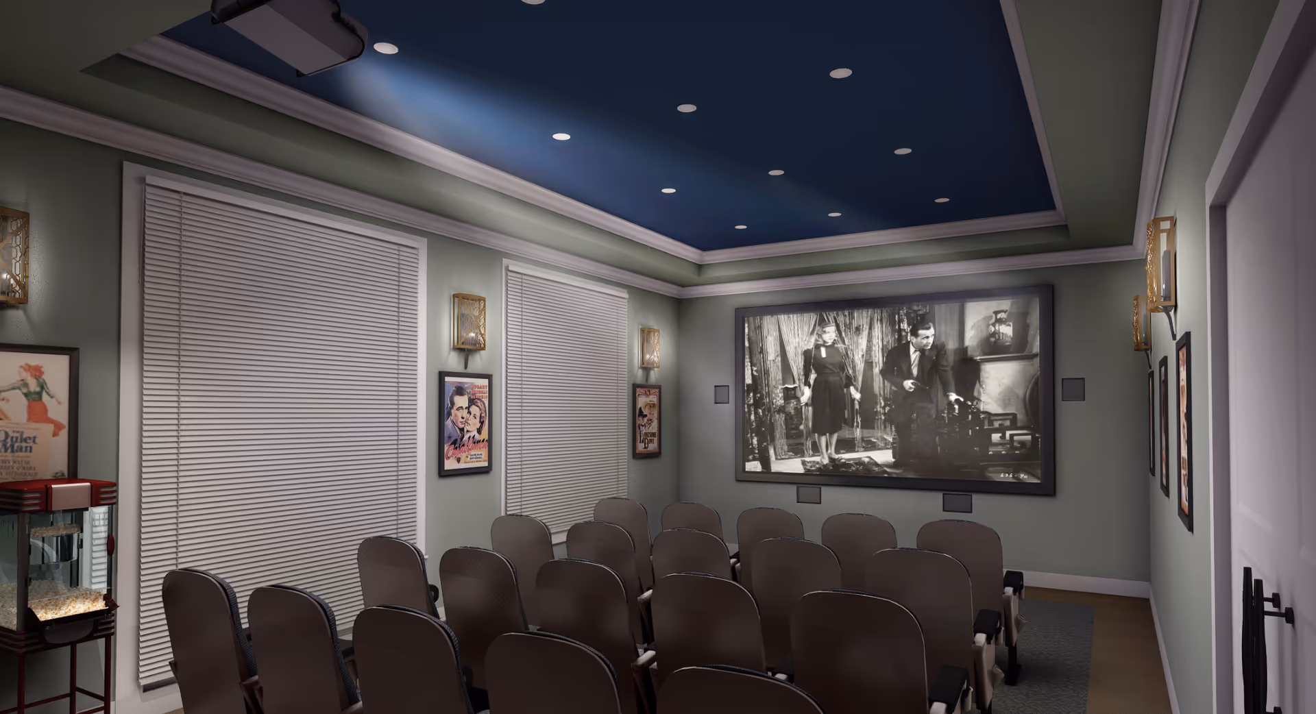 A small screening room with rows of theater chairs facing a large screen showing a black-and-white film, framed posters on the walls, and a popcorn machine.