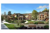 Exterior view of HearthSide Peachtree City senior living facility showing a large building with multiple windows and balconies, surrounded by landscaped gardens, trees, benches, and walking paths under a blue sky with a few clouds.