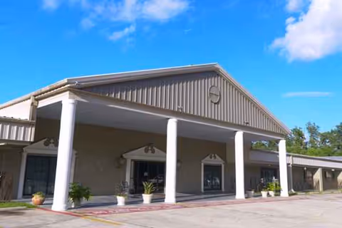 Front exterior of Pontchartrain Health Care Center with a covered entrance and columns.