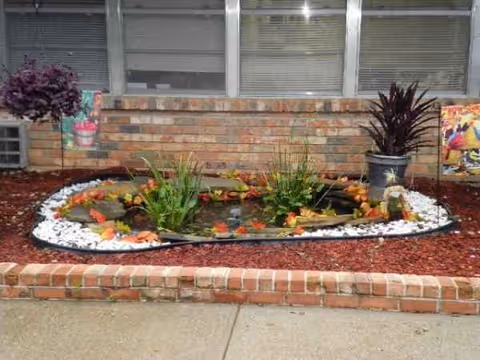 Front exterior of Desoto Retirement & Rehab Center with a circular garden bed.