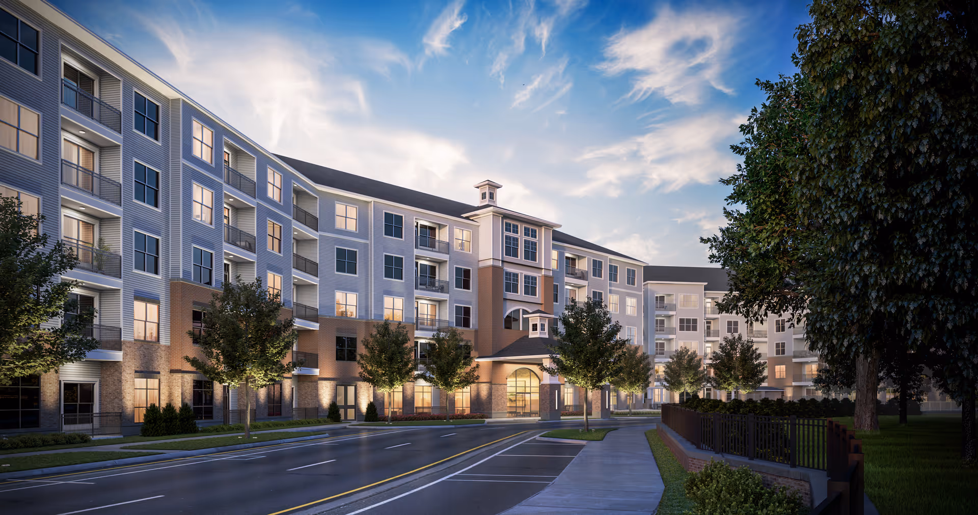 Exterior of Overture Cary senior living, a multi-story building with a curved entrance and campus trees.