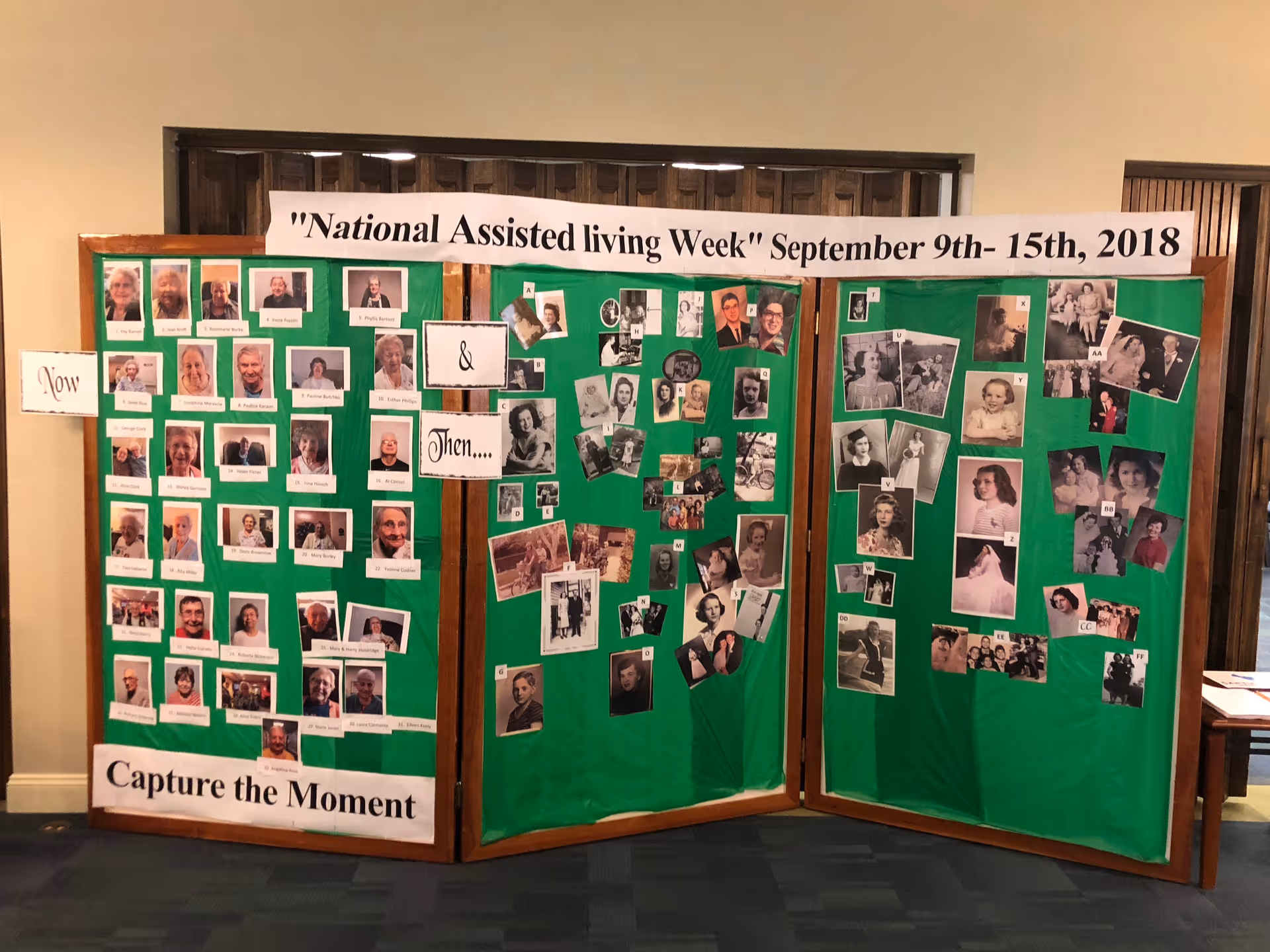 A three-panel display board with a green background featuring photographs of people labeled 'Now' on the left panel and 'Then' on the middle and right panels. The display is titled 'National Assisted living Week September 9th-15th, 2018' and includes the phrase 'Capture the Moment' at the bottom left.