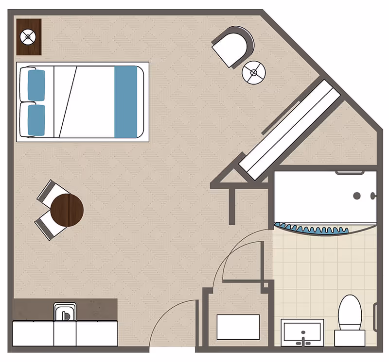 Floor plan of a studio apartment featuring a bed with two pillows and a blanket, a small round table with two chairs, a kitchenette with a sink, a bathroom with a bathtub, toilet, and sink, and a closet area with a bench and a chair.