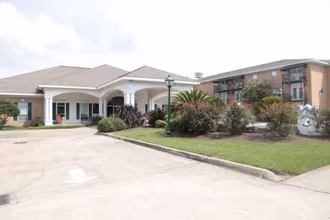 Exterior view of Villa Maria Retirement Center with arched entrance and landscaped grounds.