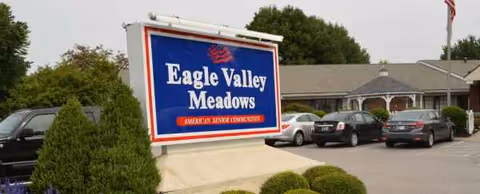 Exterior view of Eagle Valley Meadows sign with parked cars outside