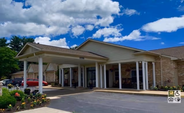 Exterior entrance of The Warren senior living facility with a covered drop-off area.
