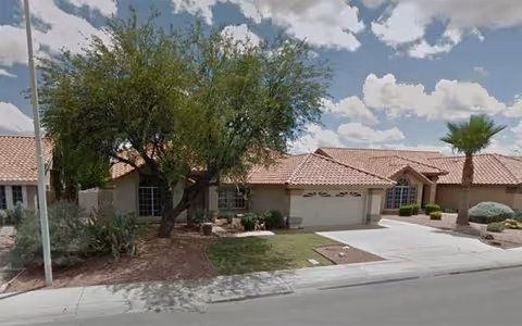 Front view of Andersen Springs Care Home III with driveway and trees.