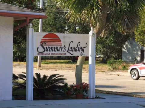 Exterior view of Summer's Landing Assisted Living entrance sign with plants.