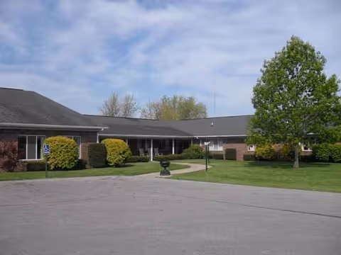 A single-story brick health care center with a manicured lawn and front entrance.