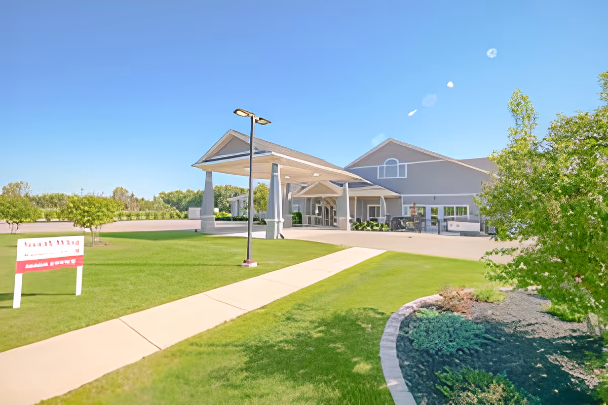Front exterior of Quality Care of Howell showing a covered entrance, driveway, and landscaped lawn.