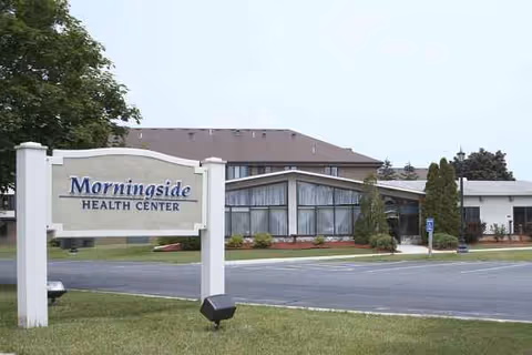 Front view of Morningside Health Center with sign and parking area.