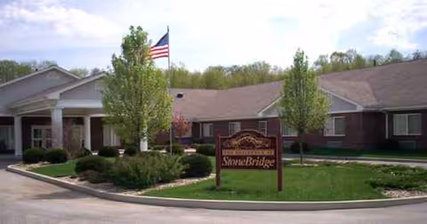 Front view of StoneBridge Health Campus building with flag, landscaping, and driveway.