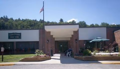 Front view of Country Side Adult Home with entrance and outdoor seating.