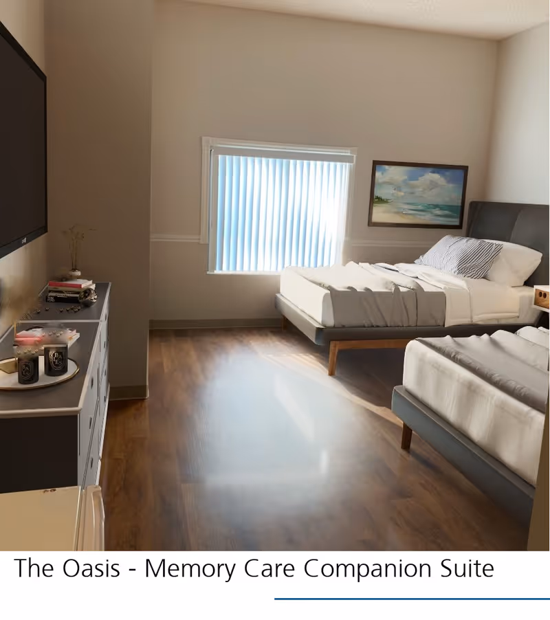 A bright bedroom with two single beds, each made with white and gray bedding. There is a window with vertical blinds letting in natural light, a dresser with decorative items and books, a wall-mounted TV, and a framed beach painting on the wall.