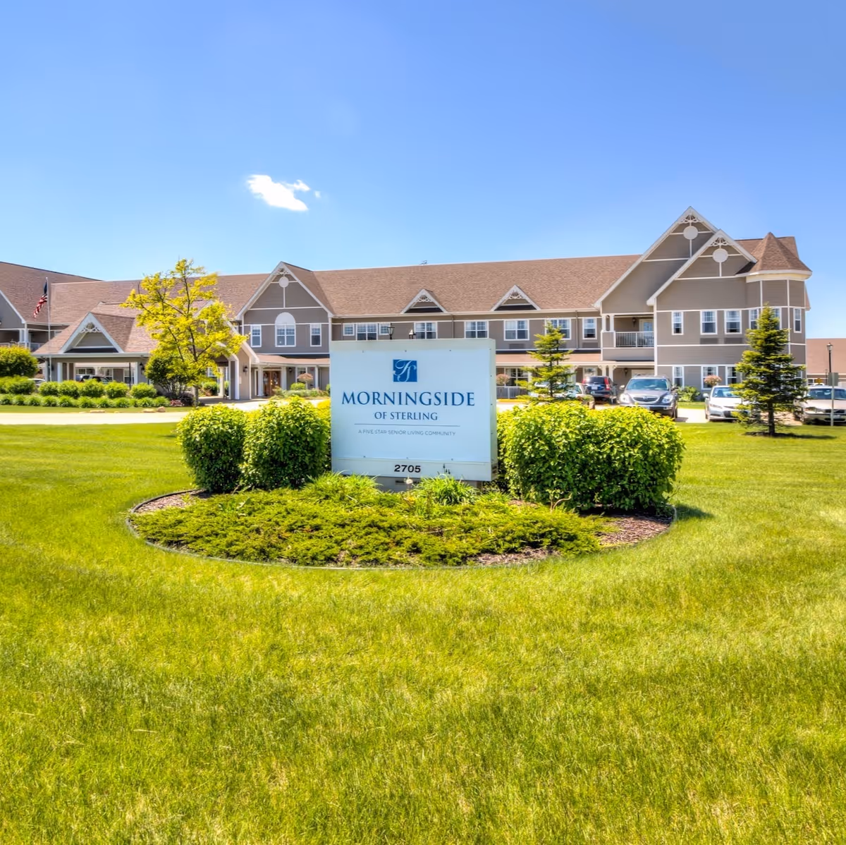 Morningside of Sterling senior living building exterior with a landscaped lawn and the facility sign in the foreground.