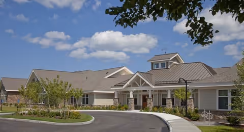 Front exterior view of Bridges by Epoch at Lexington, with curved driveway and landscaping.
