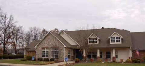 Exterior view of The Wyndmoor of Evansville, a single-story senior living facility with brick facade.