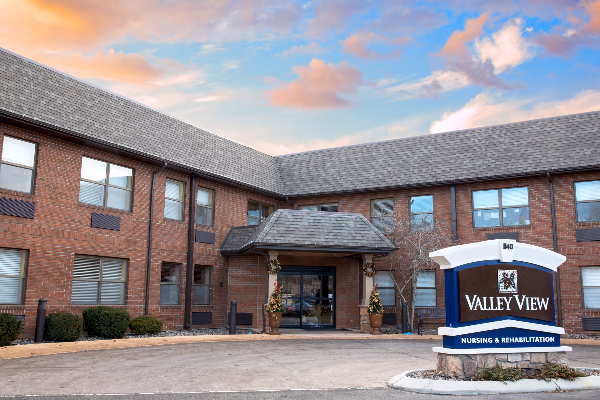 Brick two-story nursing and rehabilitation building with an entrance canopy and a 'Valley View' sign in front.
