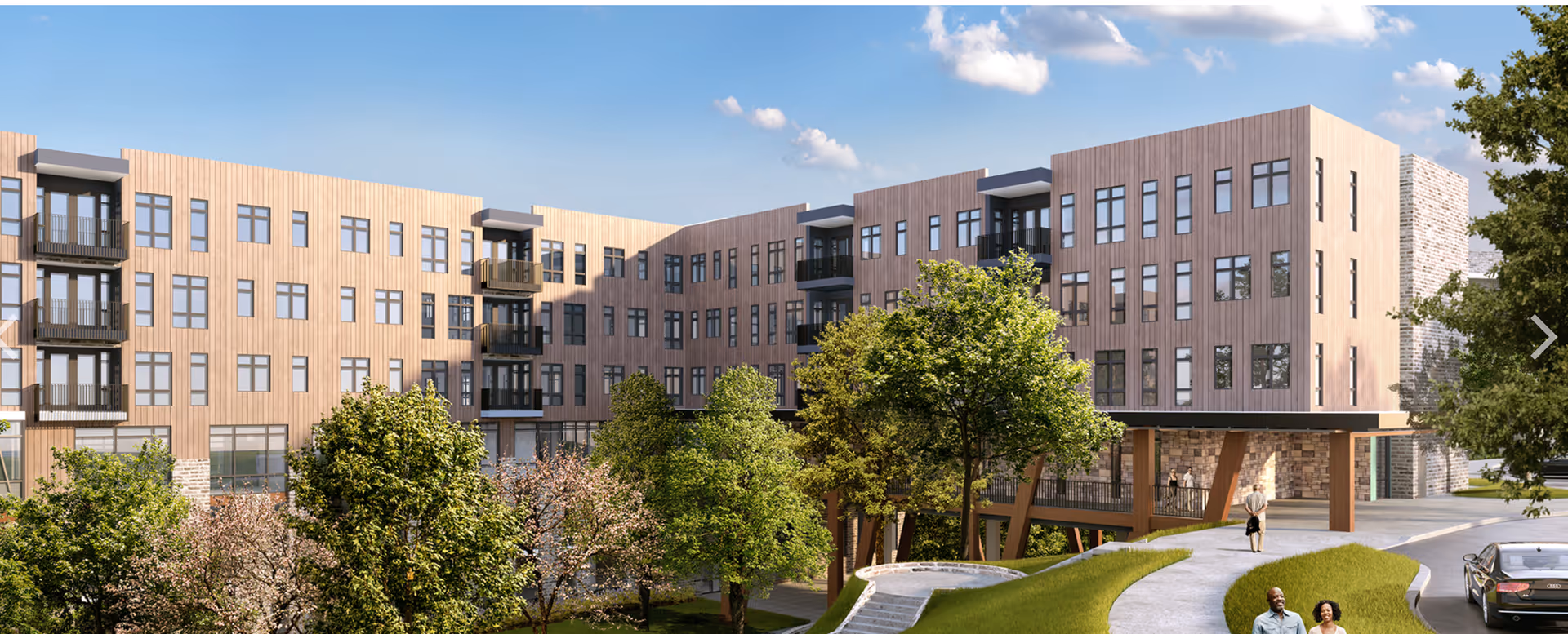 Exterior view of a modern multi-story senior living building with balconies, trees, and a curved walkway with people.