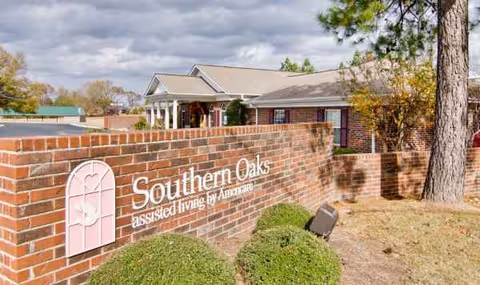 Brick wall sign for Southern Oaks Assisted Living with building facade in background