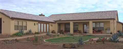 Desert Hills Adult Care Home exterior with circular garden and porch seating