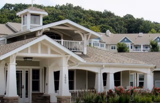 Exterior view of Rosecrest Residence with a covered entry, columns, and balconies.