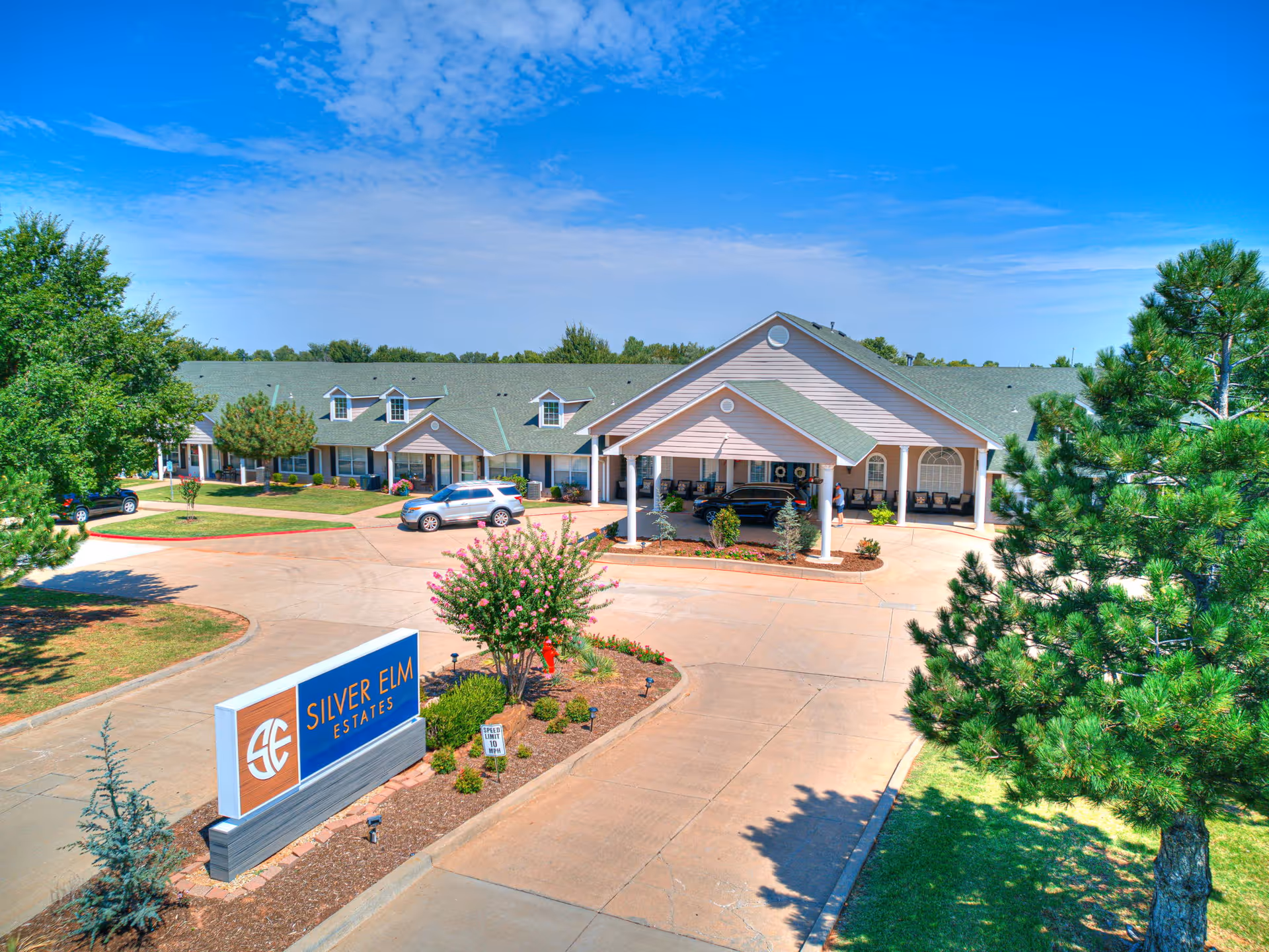 A senior living facility front with a covered entrance and Silver Elm Estates sign.