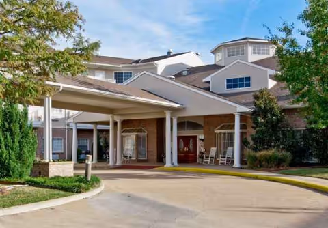 Exterior view of The Waterford at Mesquite with a covered entrance and brick facade.