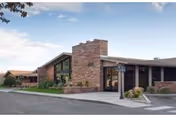 Exterior view of Pikes Peak Post Acute facility with brick facade and front entrance.