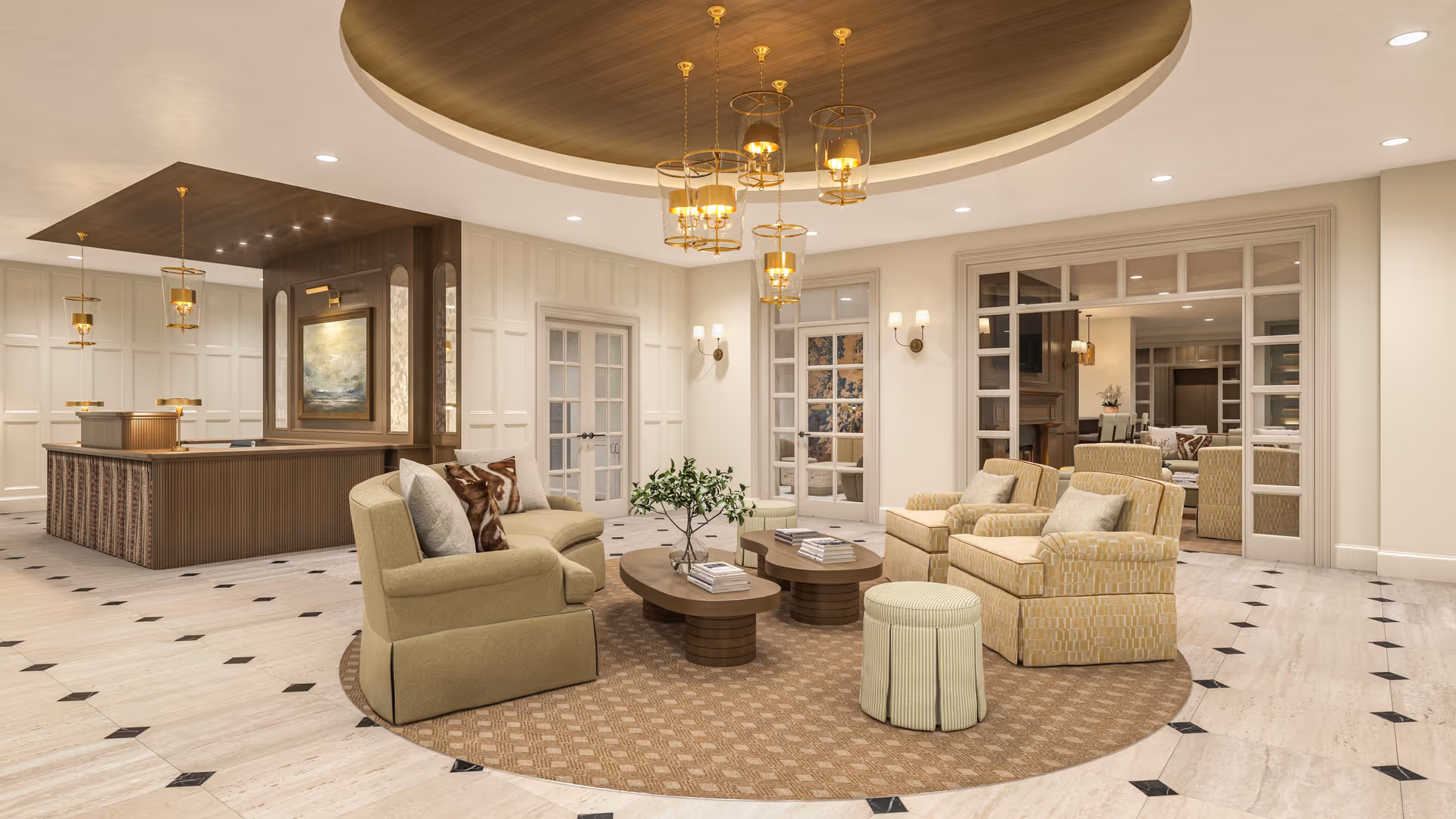 A spacious and elegant living room area with beige and light brown upholstered chairs and sofas arranged around two round wooden coffee tables on a patterned circular rug. The room features a high ceiling with a recessed circular design and multiple gold pendant lights. The walls are light-colored with decorative paneling, wall sconces, and large glass-paneled double doors leading to another room.