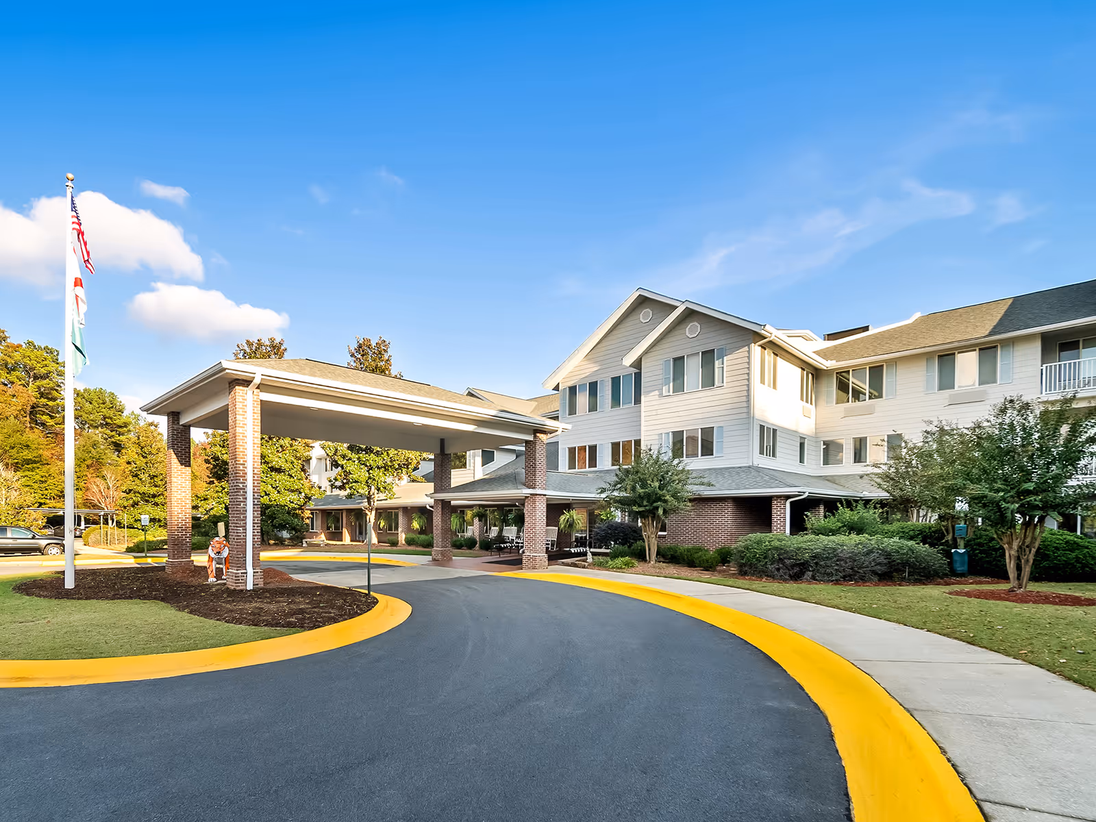 Exterior view of Monarch Estates with a covered entrance and curved driveway.